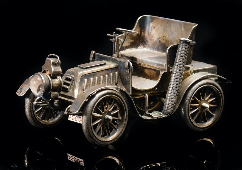An Edward VII Novelty Hallmarked Silver Table Lighter Formed As A Veteran Car, London 1903, Length 14Cm. Sold For £3,300