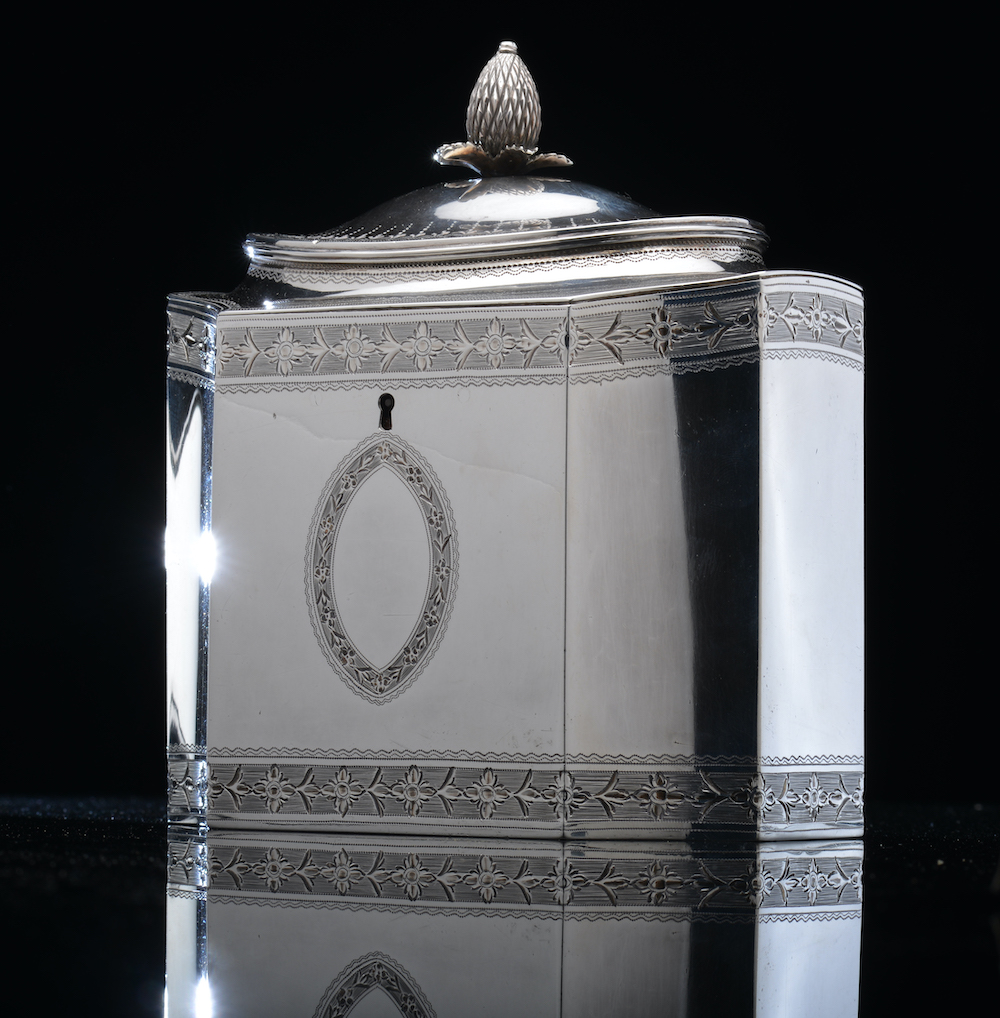 A Georgian Hallmarked Silver Tea Caddy, Of Neoclassical Form With Incuse Corners, Shaped Lid And Bright Cut Decoration, London 1790, Maker John Robins Sold For £950
