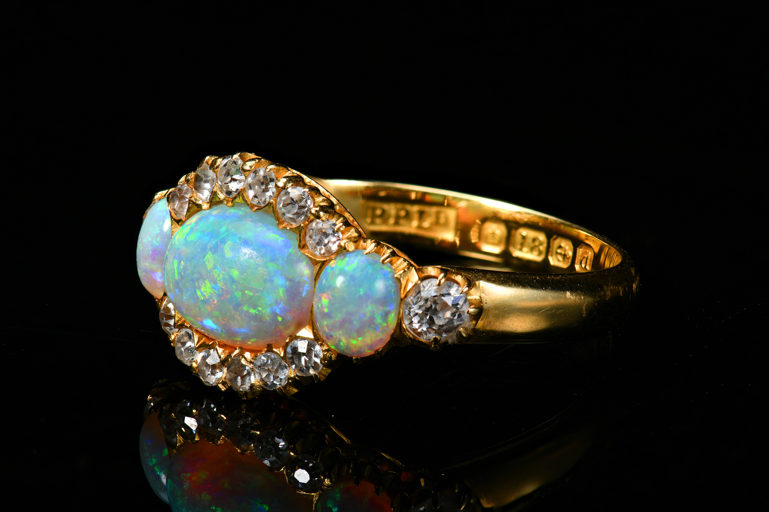 An 18Ct Gold Ring Set With Three Opals And Old Cut Diamonds. Sold For £1,100