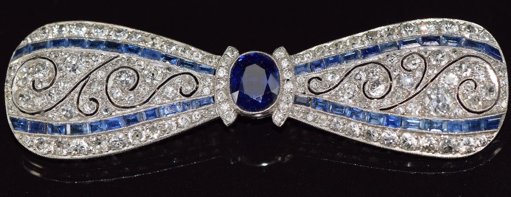 Platinum Brooch In The Form Of A Bow Set With An Oval Cut Sapphire.. Sold For £3,200